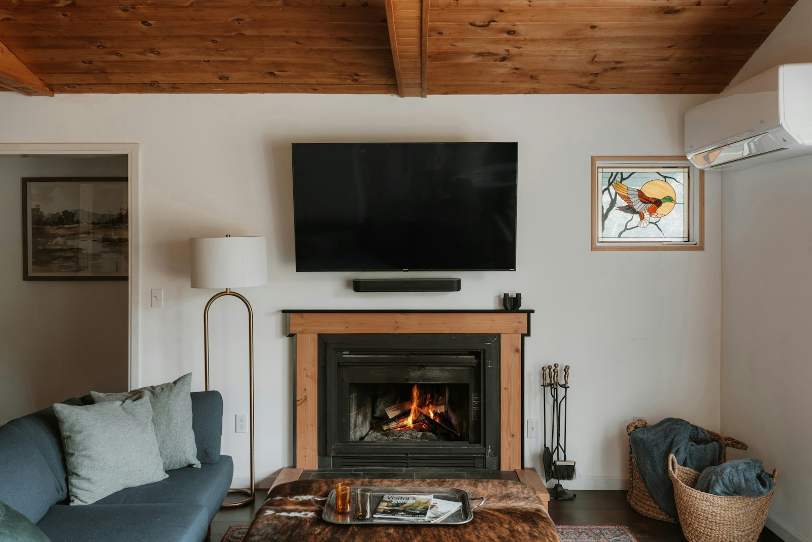 Living room with a TV mounted above a fireplace